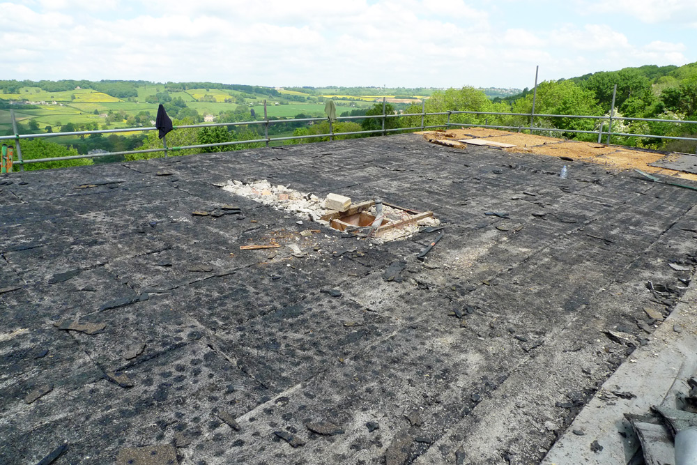 Demolition - Roof removal, 3 layer mineralised finish bituminous felt on wood wool slabs with straw over extension