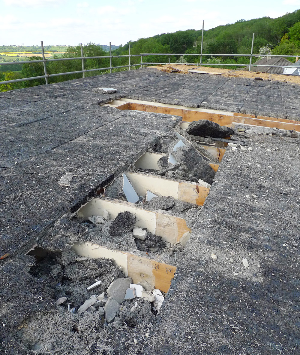 Demolition - Roof removal, 3 layer mineralised finish bituminous felt on wood wool slabs with straw over extension