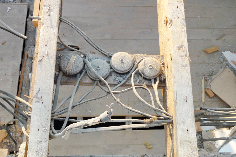 Demolition - Upper floor joists with electrical junction boxes and a mix of PVC and rubber wiring