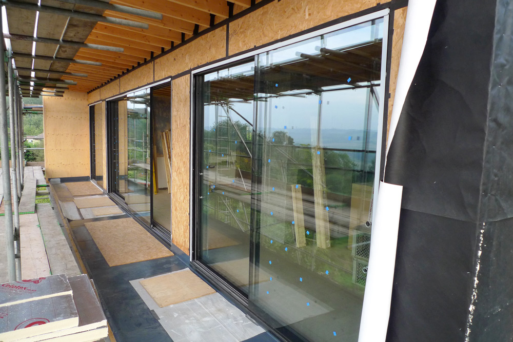 Rebuild - Upper floor glazing, balcony waterproofing, timber infills & airtightness taping