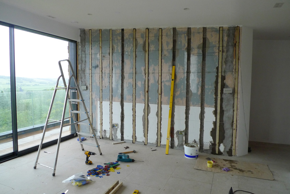 Rebuild - Upper floor living area with battens being installed on interior masonry wall