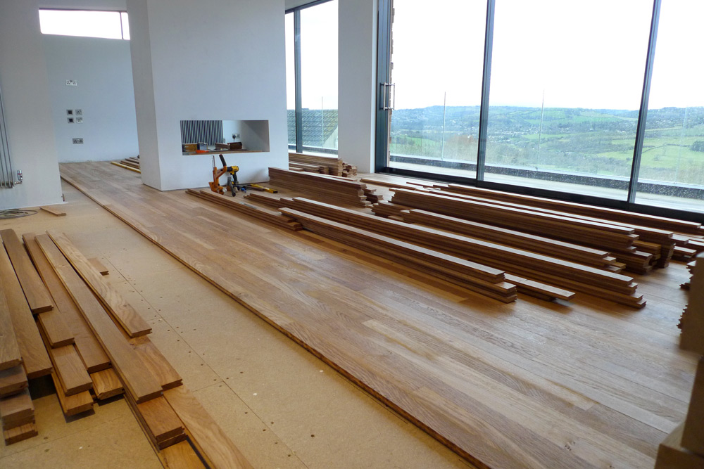 Rebuild - Laying of English Tiger Brown Oak flooring on upper floor