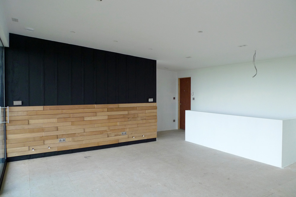 Rebuild - Upper floor living area, black wall with battens and English Oak interior cladding